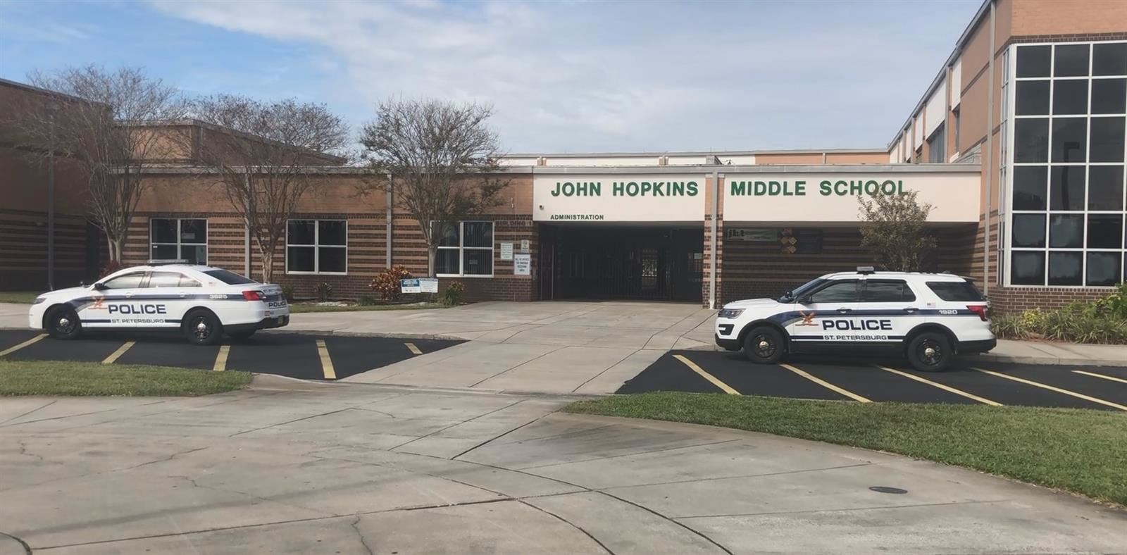  Police cars keeping the perimeter of the school secure at J.Hop.